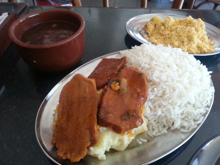 Sauteed beef tongue with mash, rice, beans, and farofa (fried cassava flour)